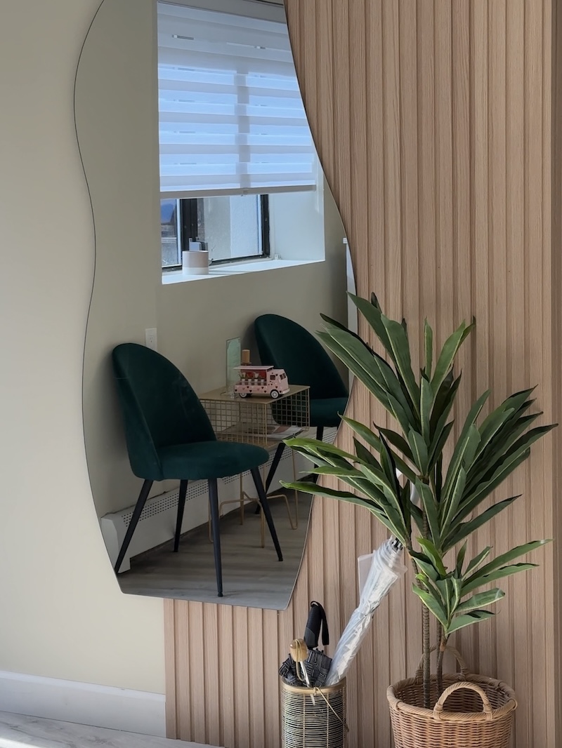 Nail Mania studio entrance with decorative mirror and seating